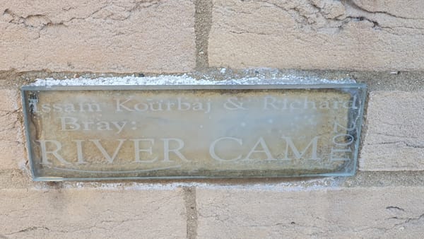 Glass artwork representing river Cam and bridges.