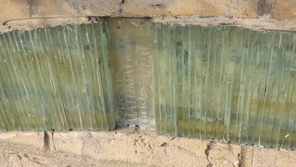 Glass artwork representing river Cam and bridges.